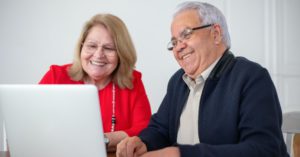 man and woman applying for medicare in texas on a laptop